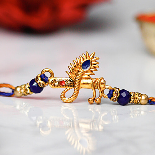 Buy eCraftIndia Designer Mor Pankh With Flute Rakhi Online at Best